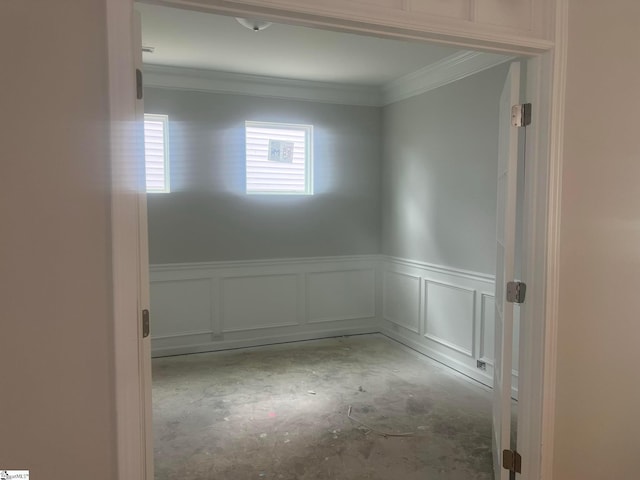 unfurnished room featuring crown molding