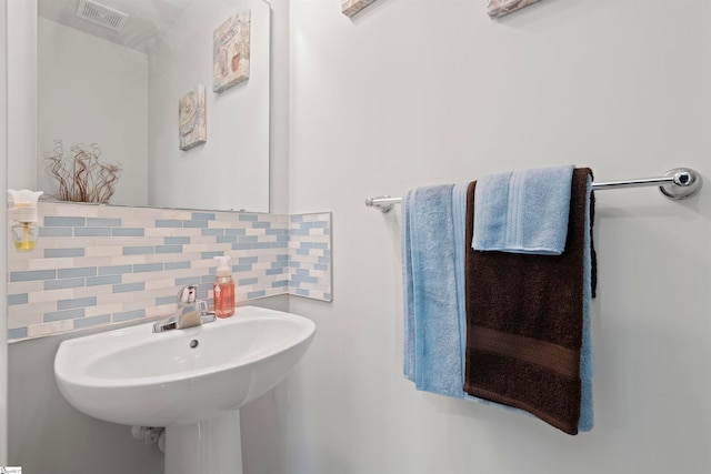 bathroom featuring tasteful backsplash