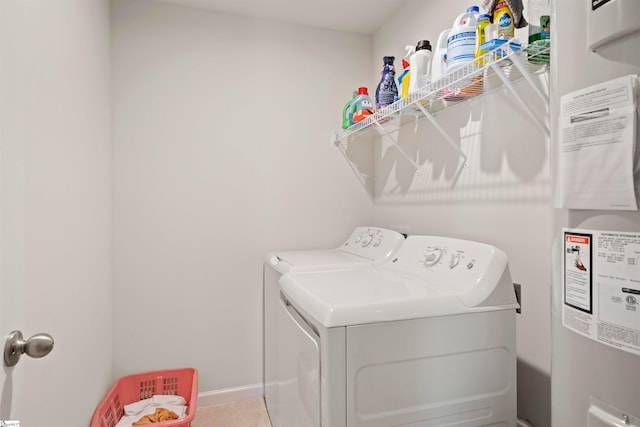 washroom featuring light tile floors and washer and dryer