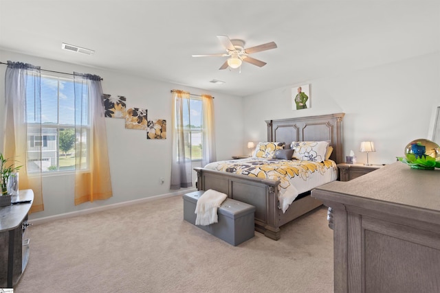 bedroom with light colored carpet and ceiling fan