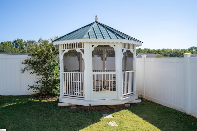 view of outdoor structure with a yard and a gazebo