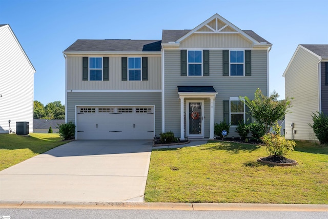 view of front of home featuring central air condition unit, a front lawn, and a garage