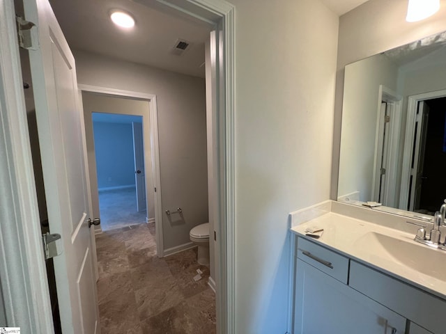 bathroom with tile floors, large vanity, and toilet