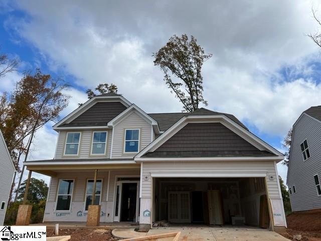 view of front of house with covered porch and a garage