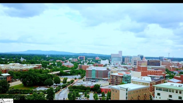 property's view of city featuring a mountain view