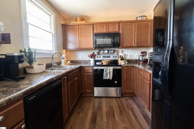 kitchen with dark wood-type flooring, sink, and black appliances