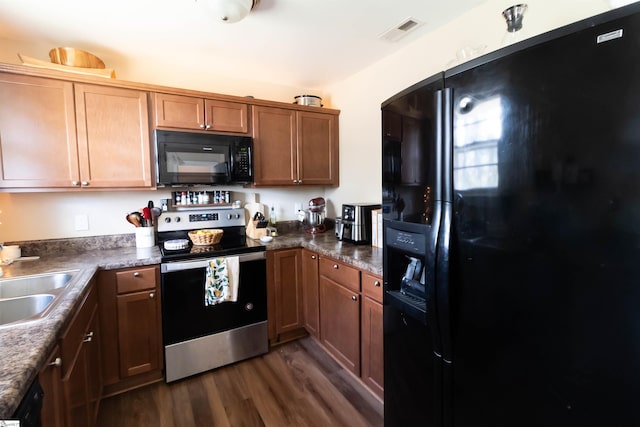 kitchen featuring sink, black appliances, and dark hardwood / wood-style flooring