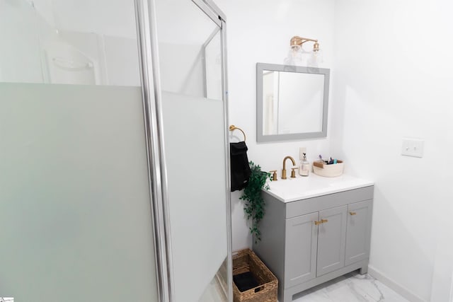 bathroom with a shower with door, tile flooring, and vanity