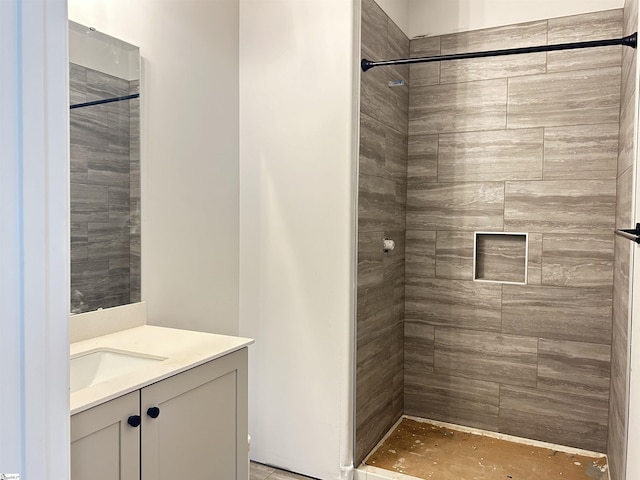 bathroom featuring vanity and tiled shower