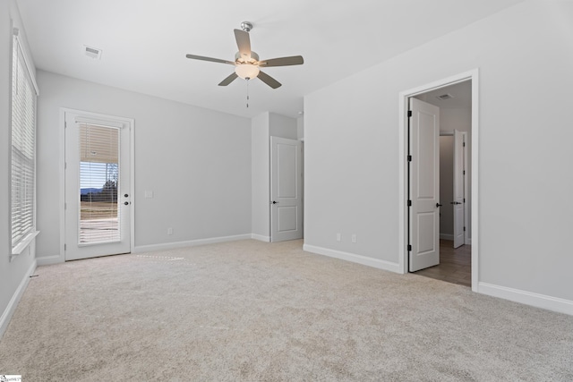 unfurnished bedroom with light colored carpet, visible vents, and baseboards