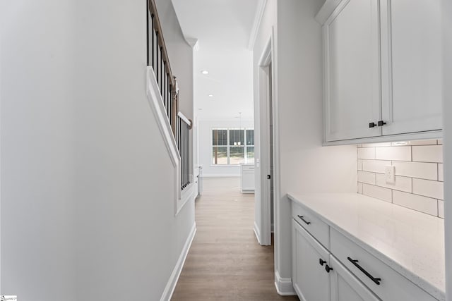 hall with recessed lighting, baseboards, and light wood finished floors