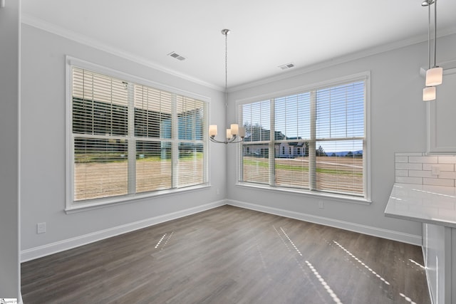 unfurnished dining area with dark wood-style floors, baseboards, and crown molding