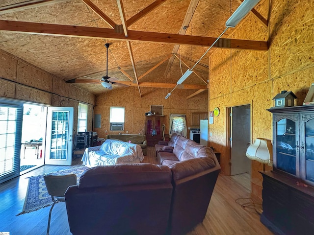 living room featuring beam ceiling, ceiling fan, and hardwood / wood-style flooring