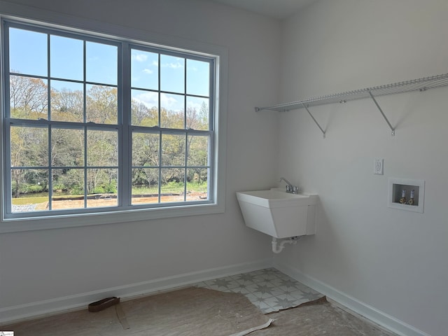 laundry room with washer hookup, a healthy amount of sunlight, and sink