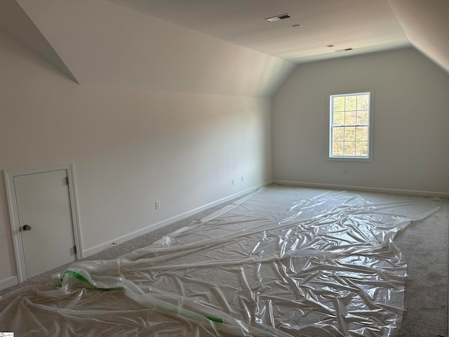 bonus room featuring light carpet and vaulted ceiling