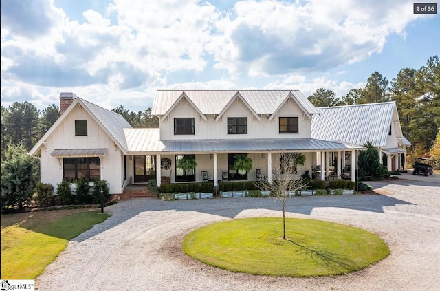 modern inspired farmhouse with covered porch and a front lawn