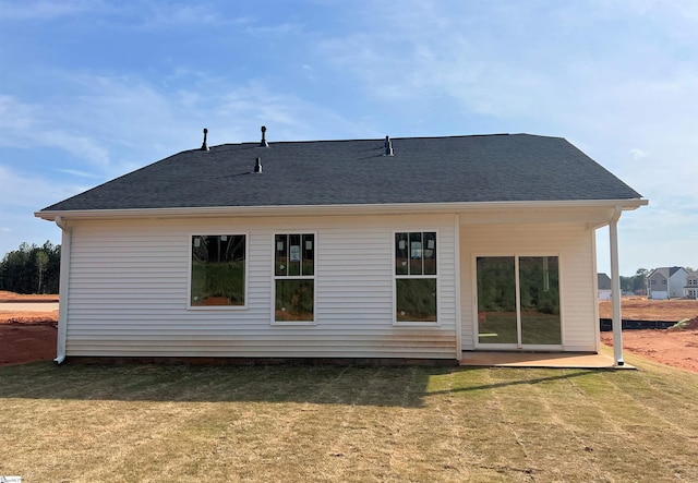 rear view of property featuring a yard