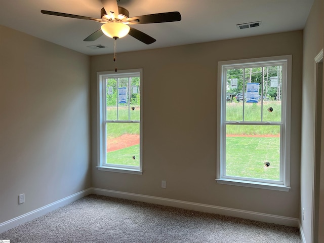 carpeted empty room with plenty of natural light and ceiling fan