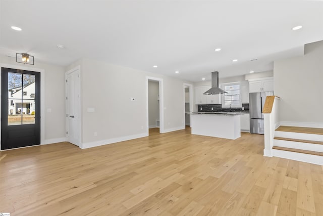 unfurnished living room with light wood-type flooring