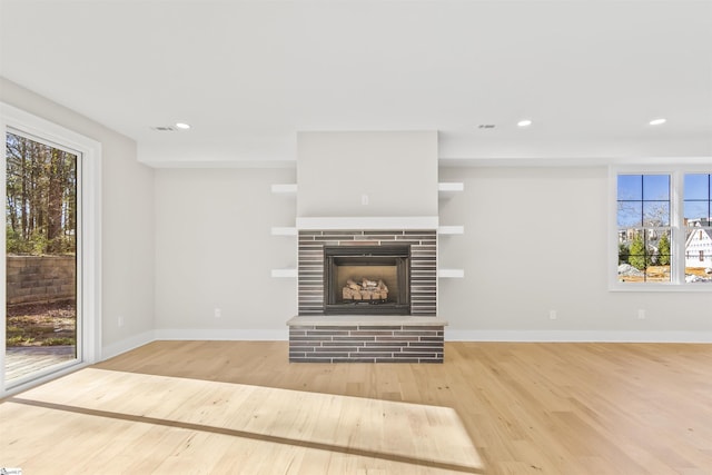 unfurnished living room featuring a fireplace and hardwood / wood-style floors