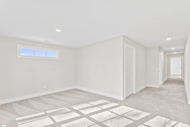 unfurnished room featuring light colored carpet