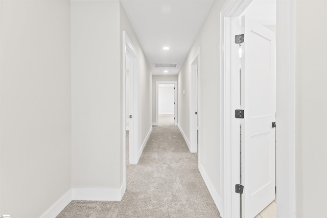 hall with light colored carpet