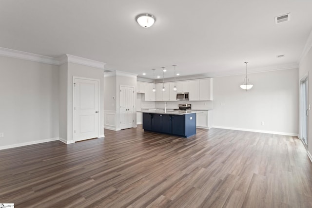 unfurnished living room featuring hardwood / wood-style flooring, ornamental molding, and sink