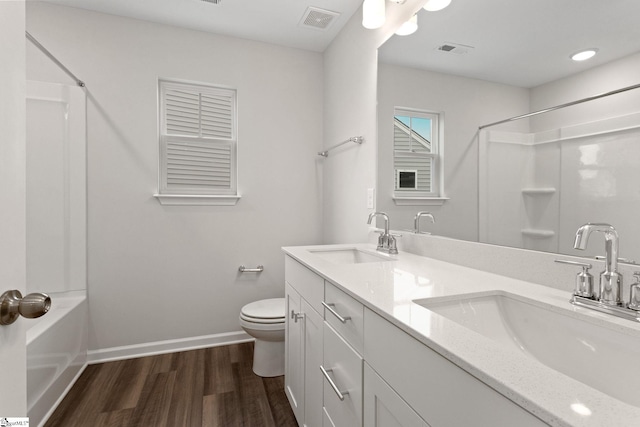 bathroom with vanity, wood-type flooring, and toilet