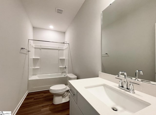 full bathroom with hardwood / wood-style flooring, vanity, shower / bathtub combination, and toilet