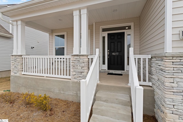 entrance to property featuring covered porch