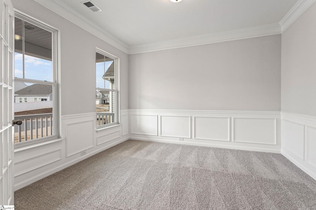 carpeted spare room with crown molding