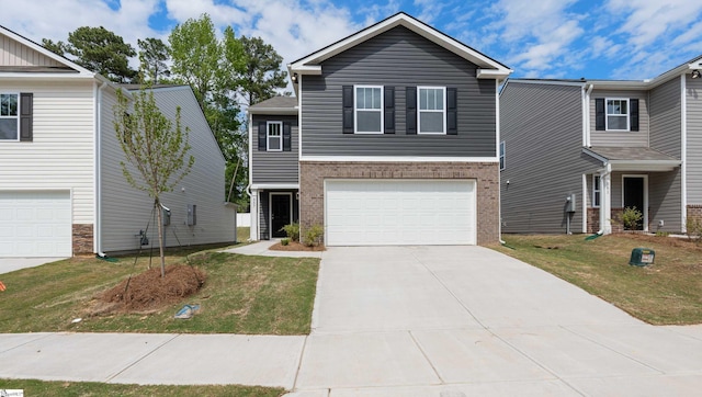 view of front of house with a garage and a front lawn