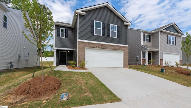 view of front of property featuring a front yard and a garage