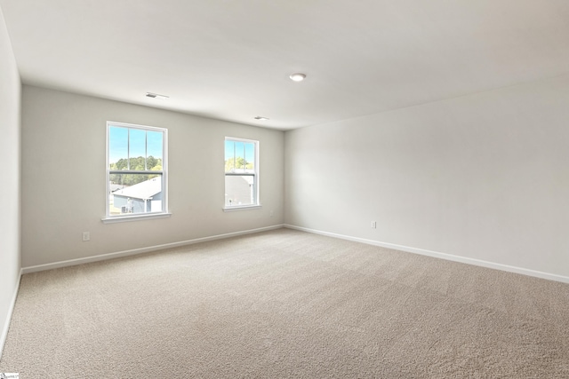 spare room with light carpet