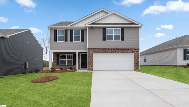 view of front of house featuring cooling unit, a garage, and a front yard