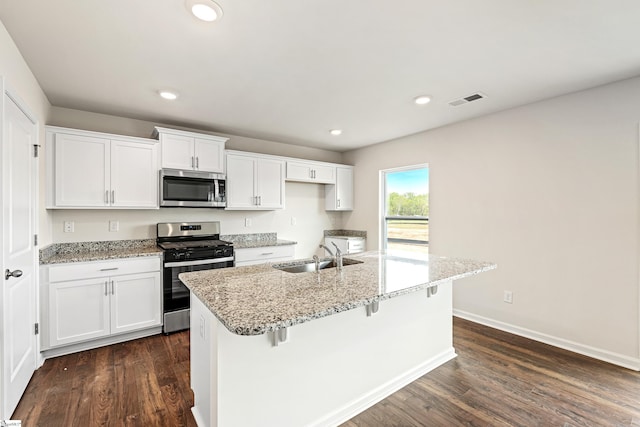 kitchen with a center island with sink, white cabinetry, sink, and appliances with stainless steel finishes