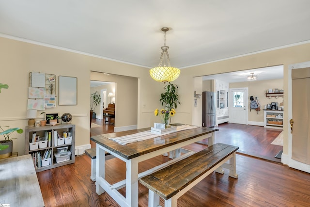 dining space featuring crown molding and dark hardwood / wood-style floors