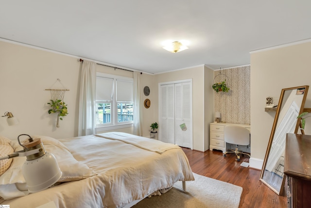 bedroom with crown molding and dark hardwood / wood-style floors