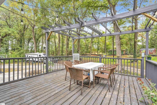 wooden terrace with a storage shed and a pergola