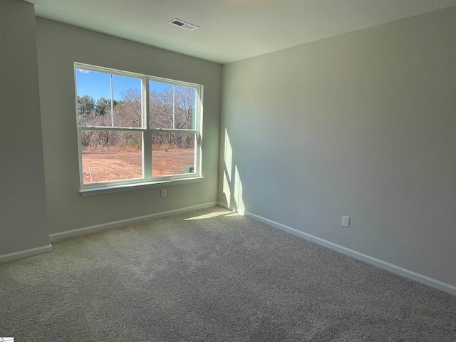 carpeted empty room with baseboards and visible vents