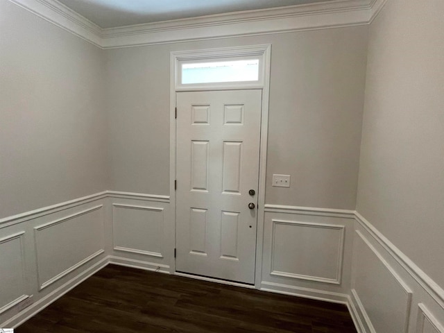 foyer with dark wood-type flooring, wainscoting, and ornamental molding