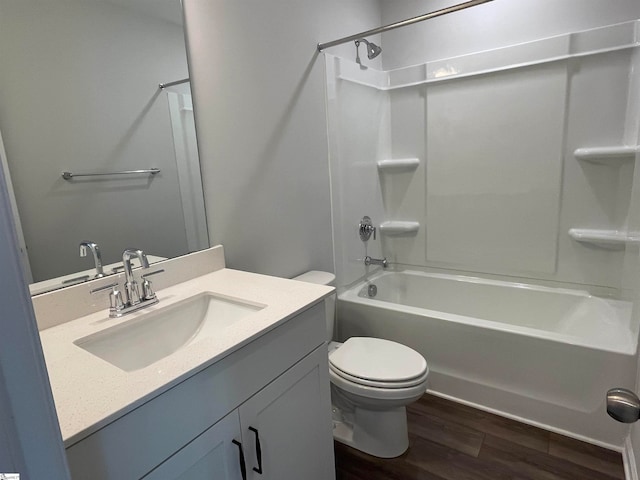 full bathroom featuring toilet, bathtub / shower combination, large vanity, and hardwood / wood-style flooring