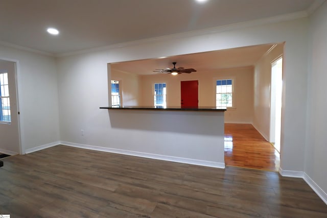 unfurnished living room with crown molding, ceiling fan, and dark hardwood / wood-style flooring