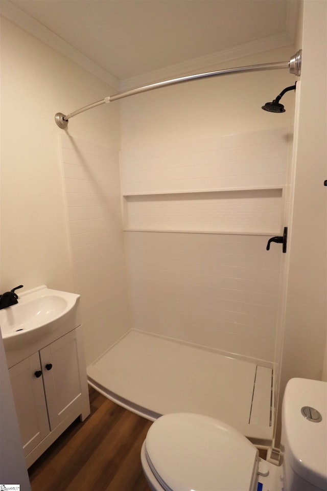 bathroom featuring walk in shower, vanity, toilet, and hardwood / wood-style floors