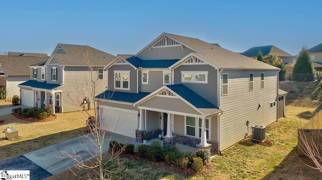 craftsman house featuring a garage, central AC, and covered porch