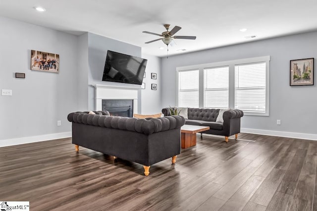 living room with ceiling fan and dark hardwood / wood-style floors