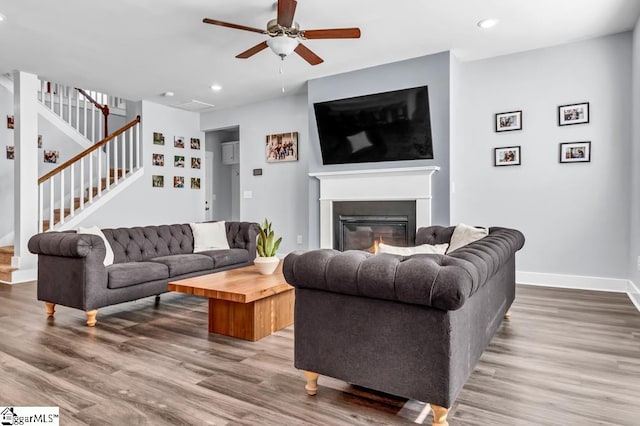 living room featuring hardwood / wood-style flooring and ceiling fan