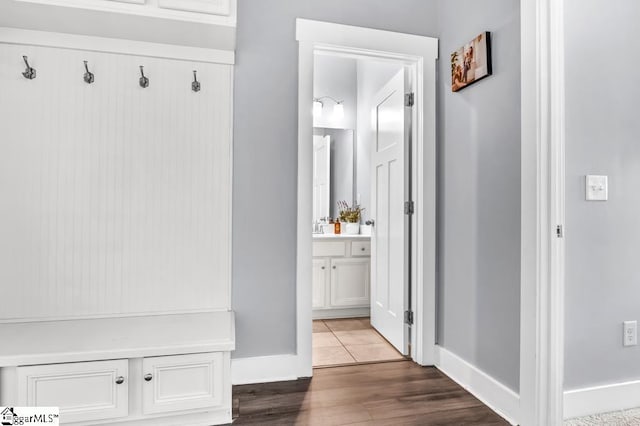 mudroom with wood-type flooring and sink