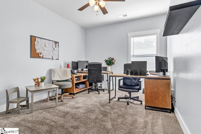 carpeted home office with ceiling fan