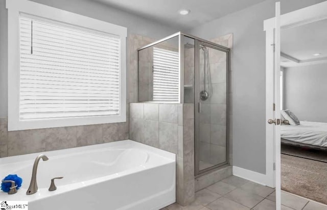 bathroom featuring tile patterned floors and independent shower and bath